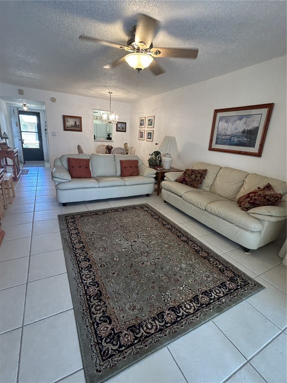 11485 Oakhurst Road, Unit 200318 Largo, FL 33774 - Photo 4 of 48 a living room with furniture and a rug