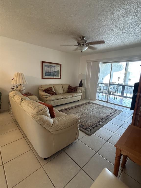 11485 Oakhurst Road, Unit 200318 Largo, FL 33774 - Photo 5 of 48 a living room with furniture and a floor to ceiling window