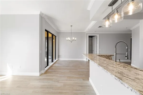 a kitchen with granite countertop a sink and refrigerator