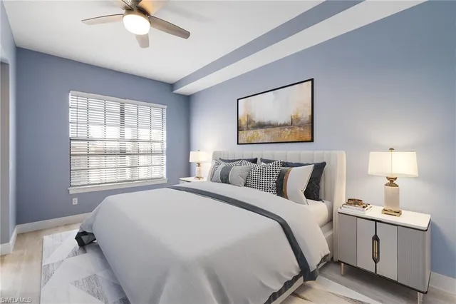a spacious bedroom with a bed and a chandelier