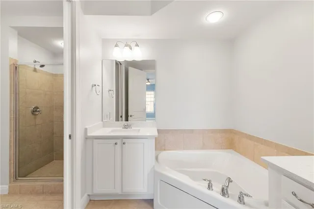 a bathroom with a tub sink and mirror