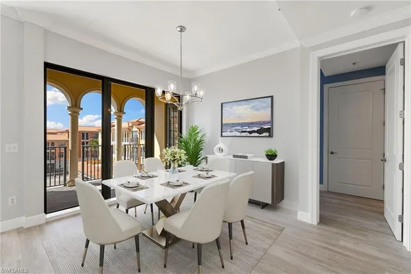 a dining room with furniture a chandelier and wooden floor