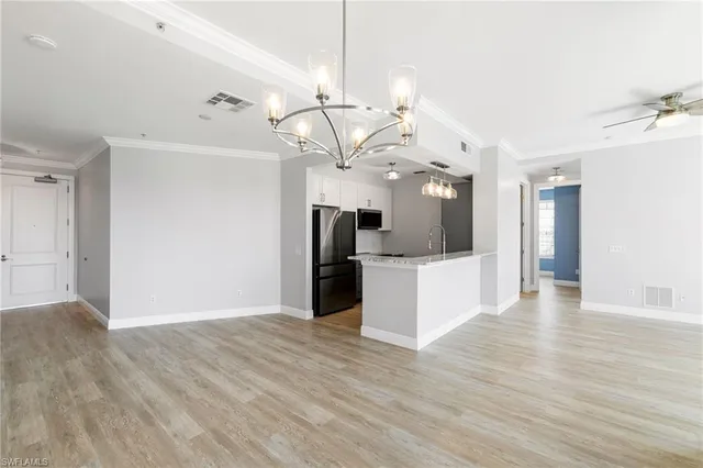 a view of a kitchen with a sink and wooden floor
