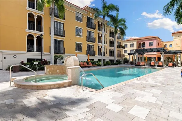 a view of a building with a yard in the background