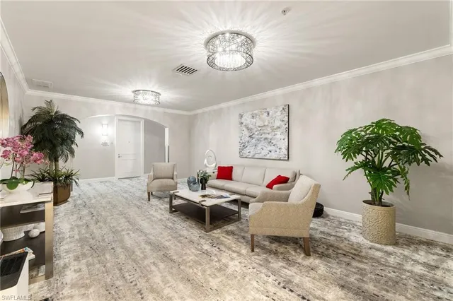 a living room with furniture and potted plant