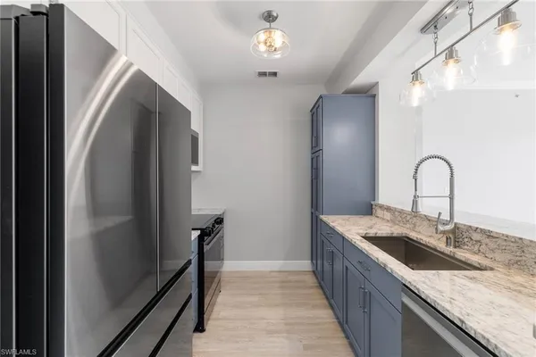 a kitchen with a sink and a refrigerator