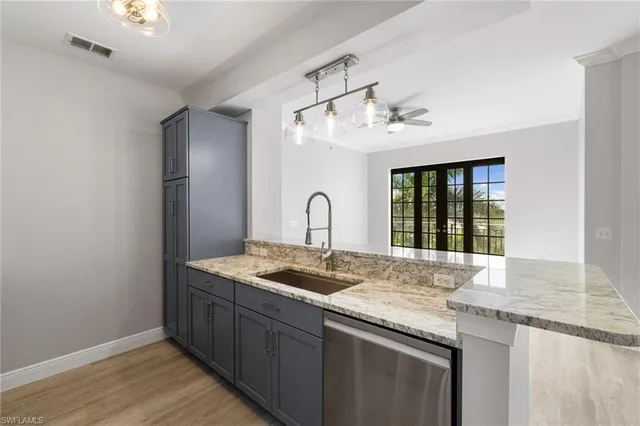 a kitchen with granite countertop a sink and a window