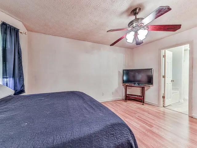 a view of a livingroom with a flat screen tv and a ceiling fan