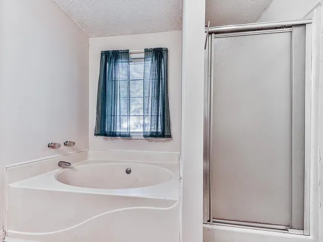 a bathroom with a bathtub and a shower