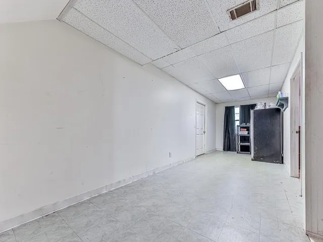 an empty room with closet and a window