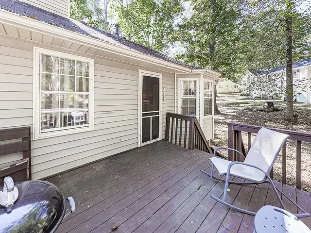 a view of a deck with table and chairs with wooden floor and fence