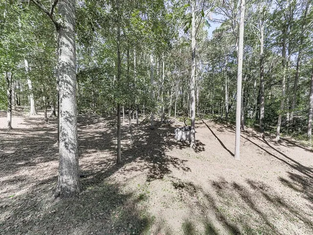 a backyard of a house with lots of trees