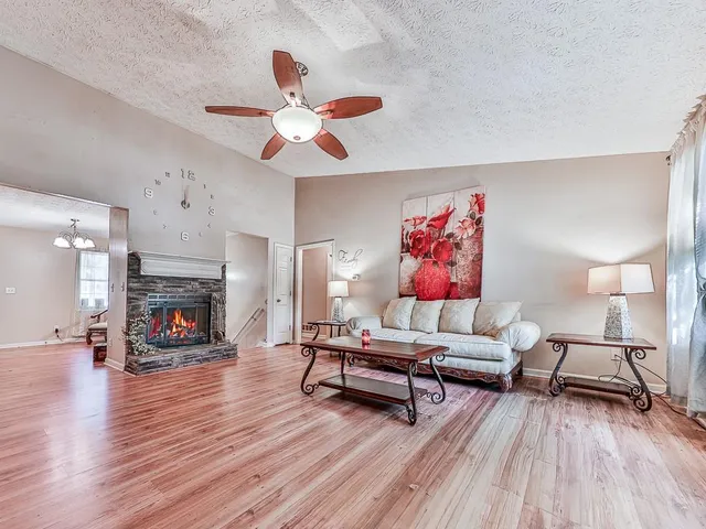 a living room with furniture and a fireplace