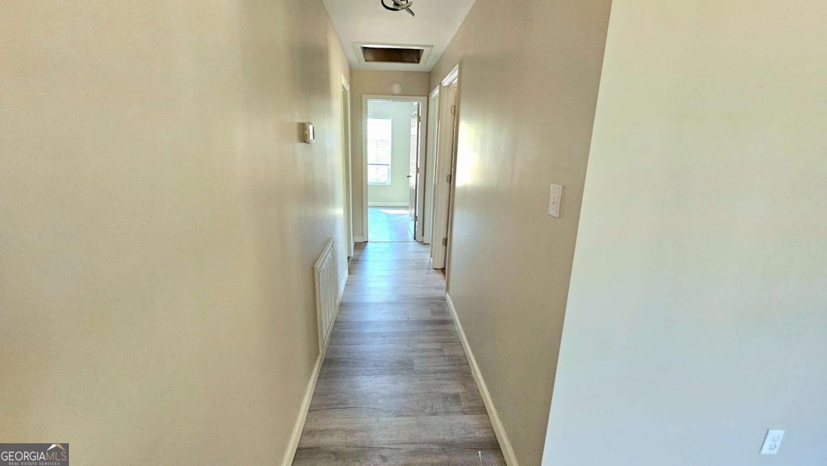 858 Augusta Road Valdosta, GA 31602 - Photo 11 of 28 a view of a hallway with wooden floor