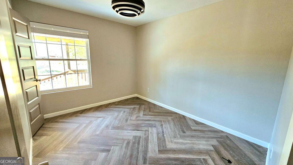 858 Augusta Road Valdosta, GA 31602 - Photo 12 of 28 a view of empty room with window and hardwood floor