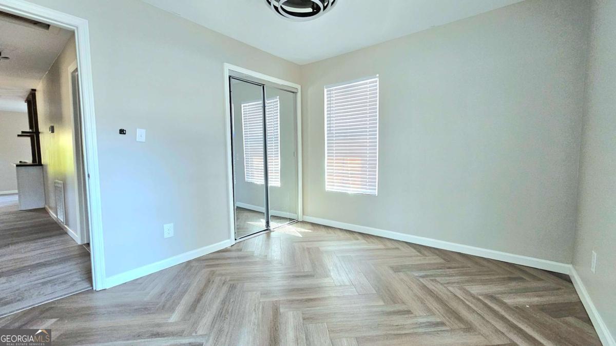 858 Augusta Road Valdosta, GA 31602 - Photo 19 of 28 wooden floor in an empty room with a window