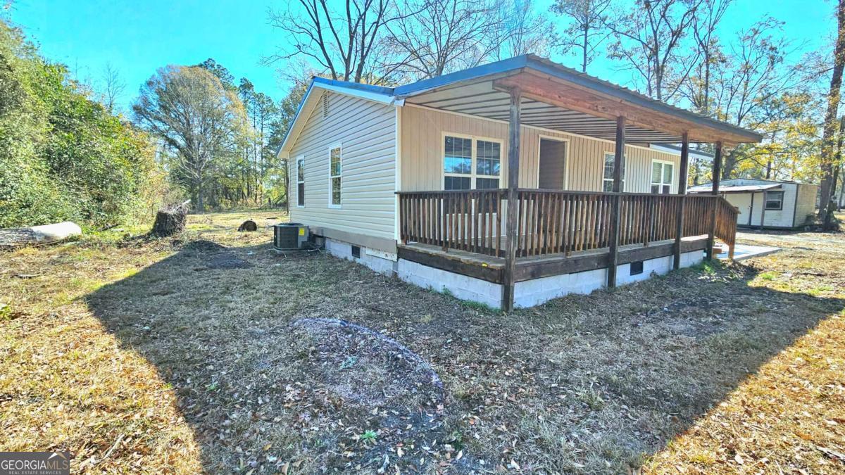 858 Augusta Road Valdosta, GA 31602 - Photo 2 of 28 a view of a house with a yard and wooden fence