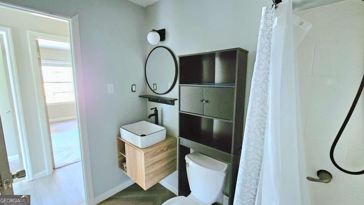 858 Augusta Road Valdosta, GA 31602 - Photo 22 of 28 a bathroom with a sink and a mirror