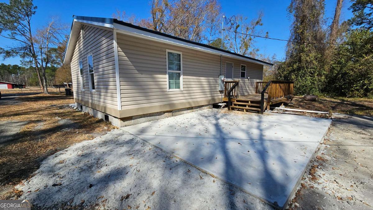 858 Augusta Road Valdosta, GA 31602 - Photo 26 of 28 a view of backyard with a chair and table