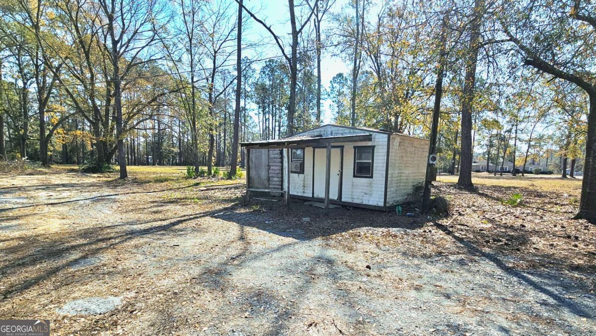 858 Augusta Road Valdosta, GA 31602 - Photo 27 of 28 a view of a house with a yard covered with snow and trees