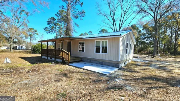 a view of a house with a yard covered in snow