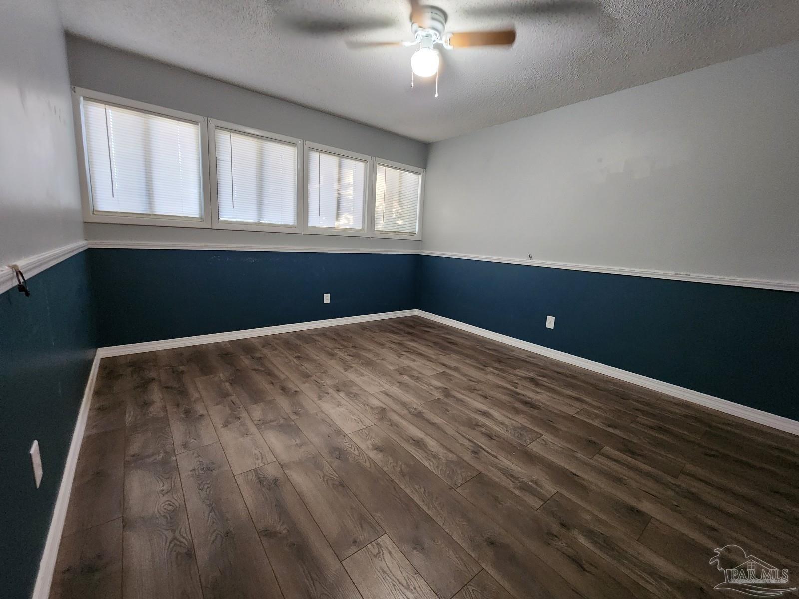 5140 Choctaw Avenue Pensacola, FL 32507 - Photo 14 of 25 wooden floor and window in an empty room