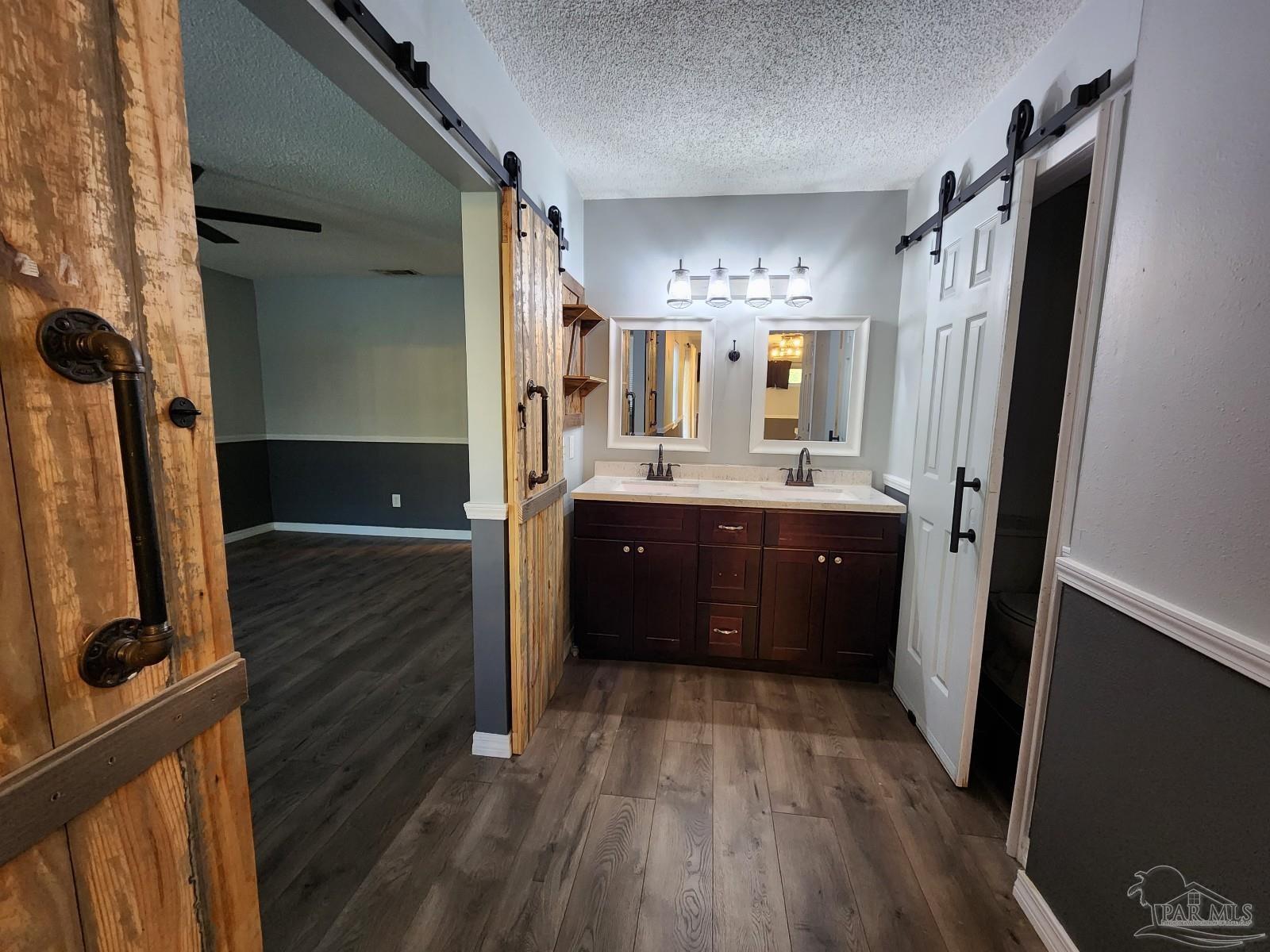 5140 Choctaw Avenue Pensacola, FL 32507 - Photo 20 of 25 a en suite bathroom with a double vanity sink and mirror