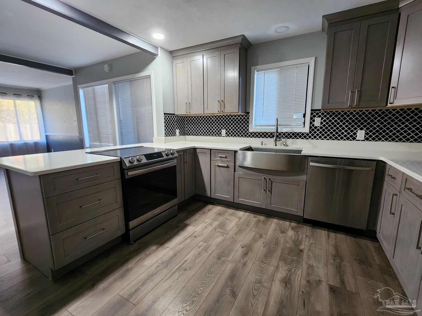 5140 Choctaw Avenue Pensacola, FL 32507 - Photo 3 of 25 a kitchen with stainless steel appliances granite countertop a sink and stove top oven