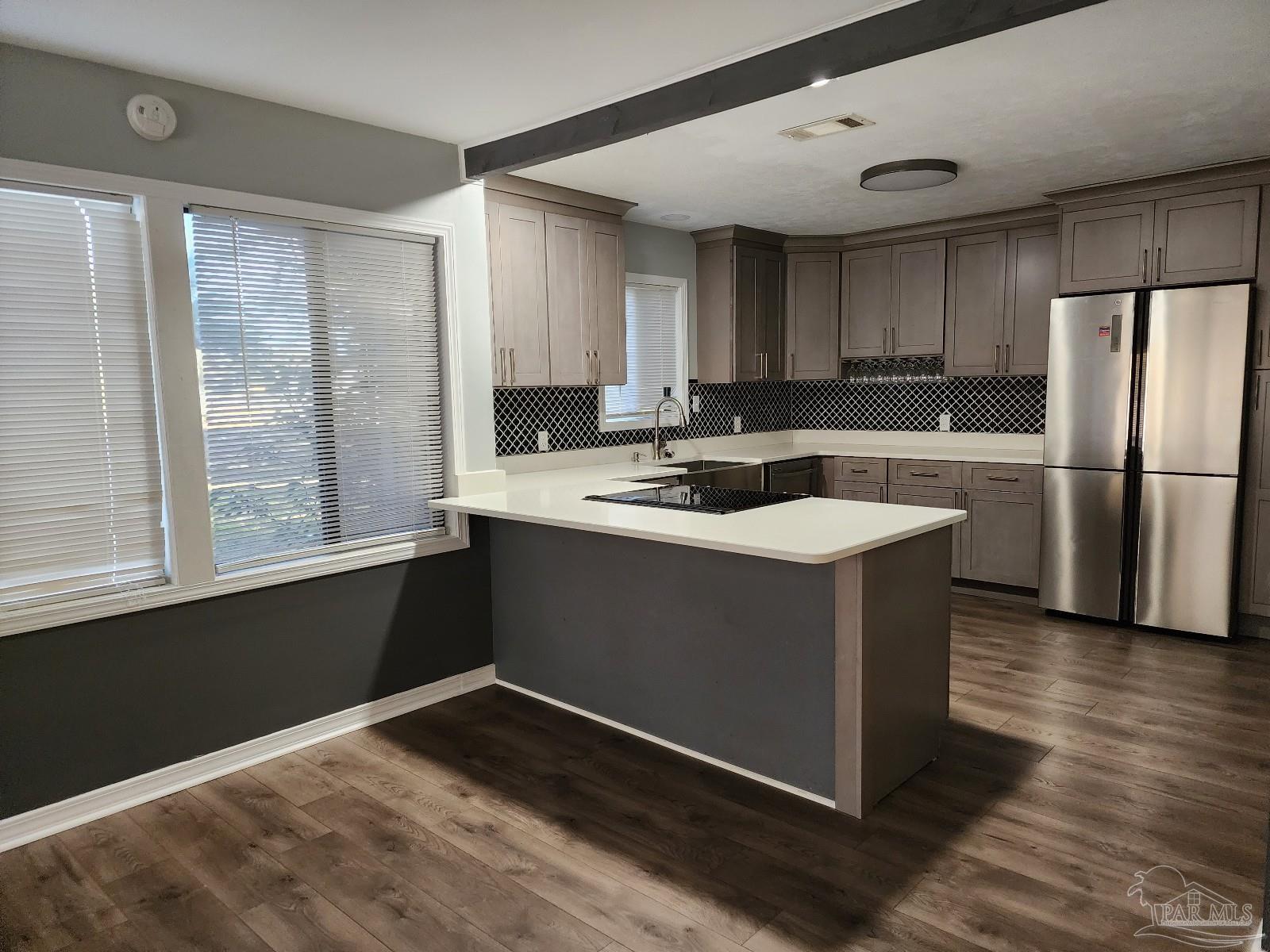 5140 Choctaw Avenue Pensacola, FL 32507 - Photo 4 of 25 a kitchen with a stove a sink and a refrigerator