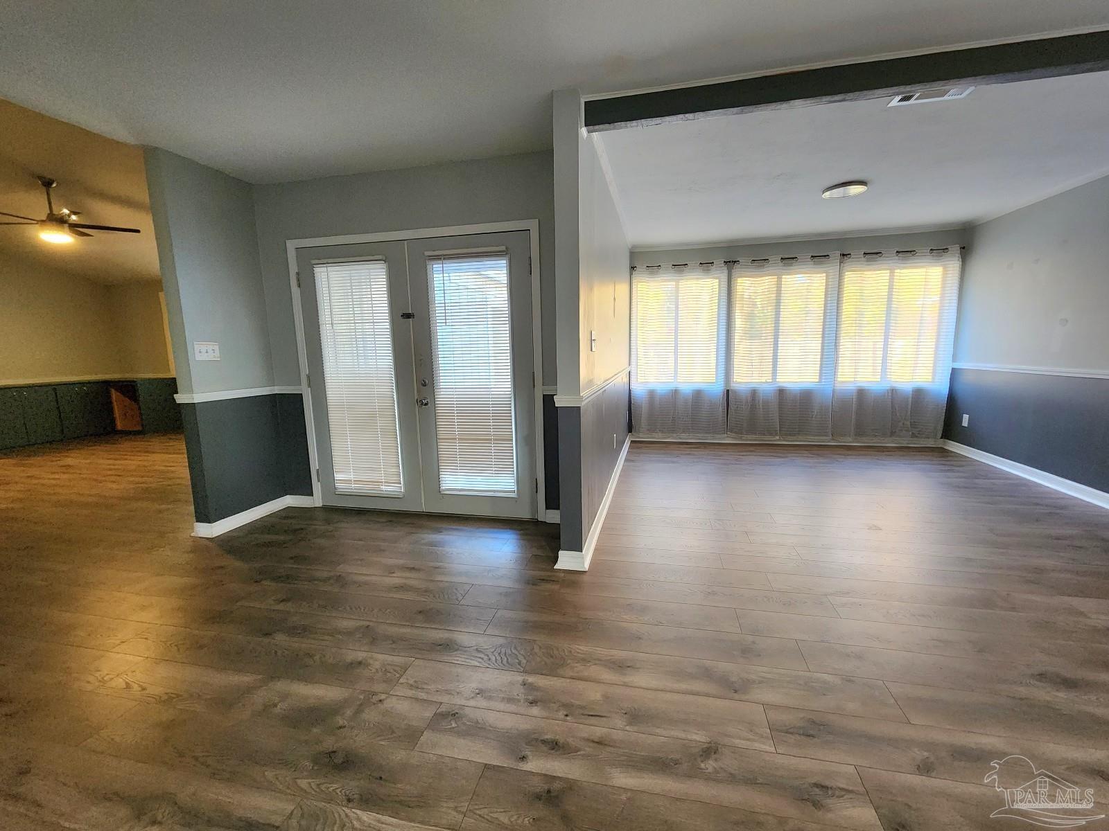 5140 Choctaw Avenue Pensacola, FL 32507 - Photo 6 of 25 an empty room with wooden floor and windows