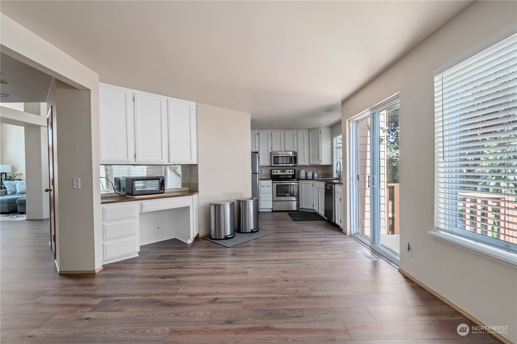 13631 Southeast 274th Place Kent, WA 98042 - Photo 11 of 31 a kitchen with stainless steel appliances wooden floors and white cabinets