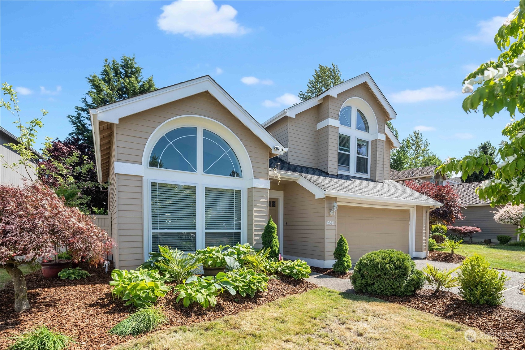 13631 Southeast 274th Place Kent, WA 98042 - Photo 2 of 31 a front view of a house with garden