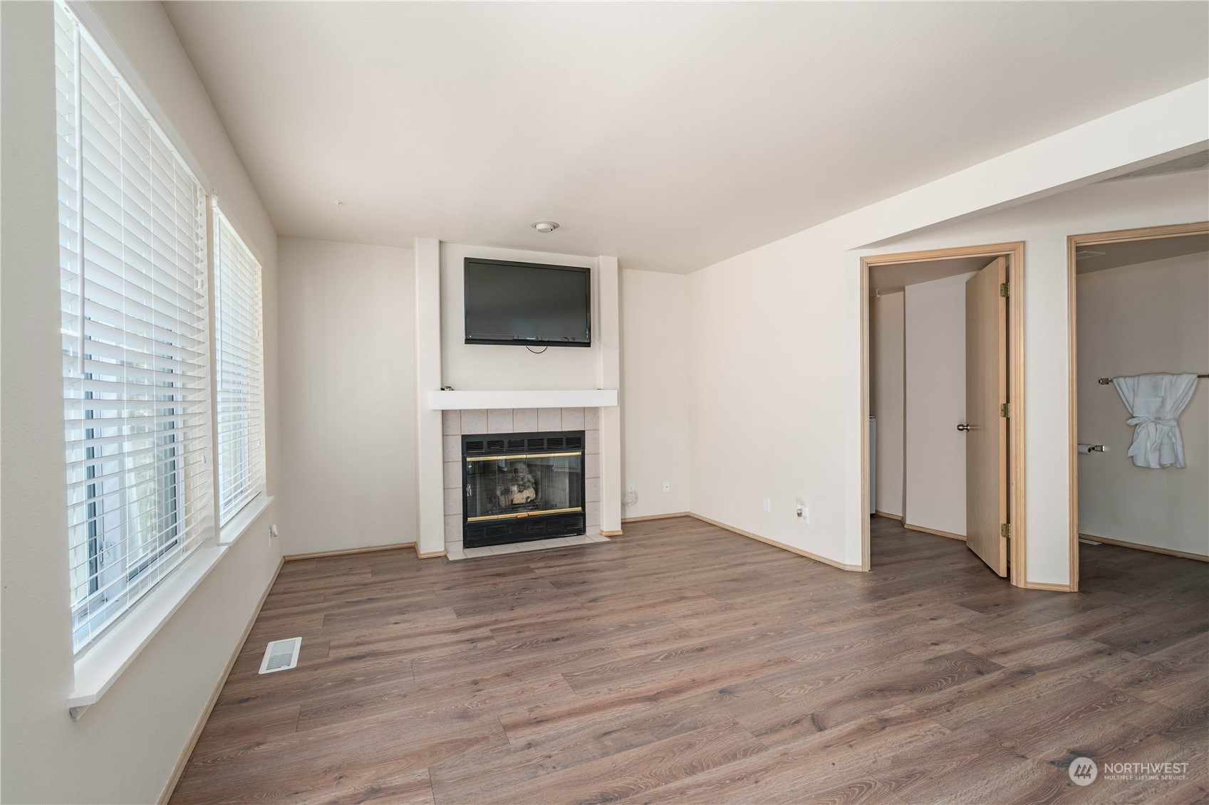 13631 Southeast 274th Place Kent, WA 98042 - Photo 10 of 31 a view of a livingroom with wooden floor and a fireplace