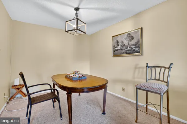 a view of a room with furniture and wooden floor