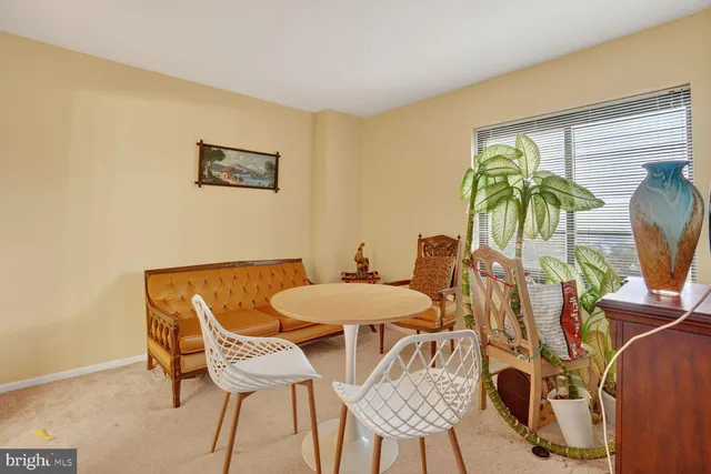 a view of a dining room with furniture and a potted plant