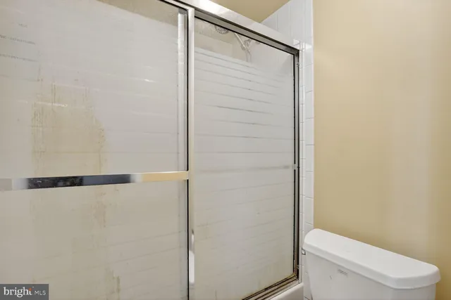 a bathroom with a toilet and a shower