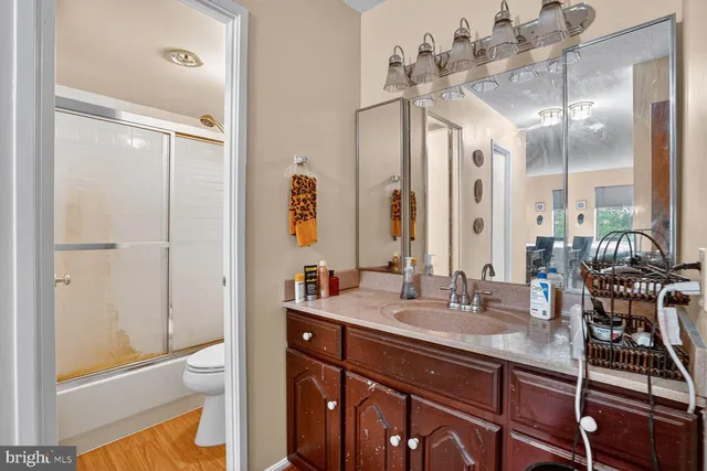 a bathroom with a double vanity sink a mirror and a shower