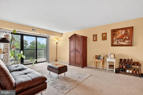 a bedroom with furniture and large windows