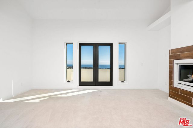 a bathroom with a granite countertop bathtub sink vanity mirror and toilet