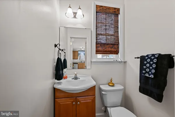 a bathroom with a sink a toilet and mirror