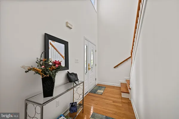 a dining room with wooden floor and a potted plant