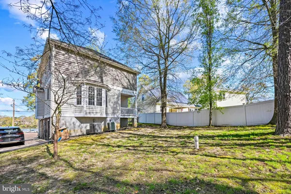 a view of a house with a yard covered with snow