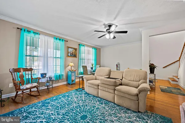 a living room with furniture a rug and a large window