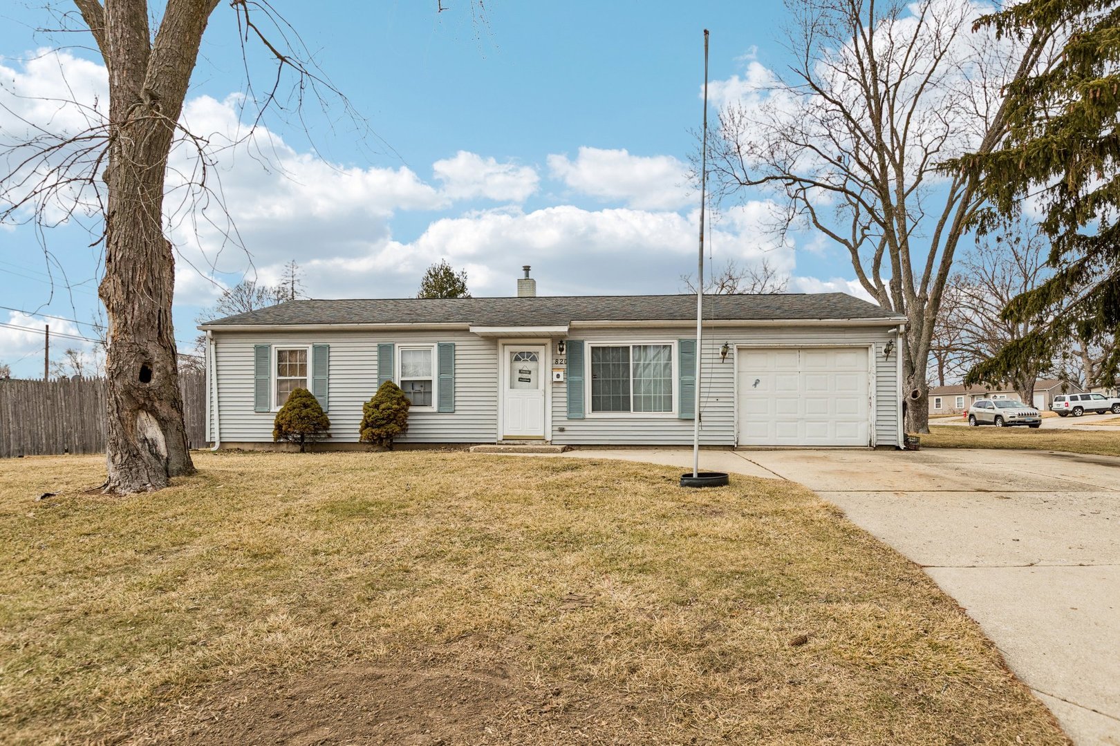 820 South Pine Street Streamwood, IL 60107 - Photo 1 of 23 a front view of a house with a yard and garage