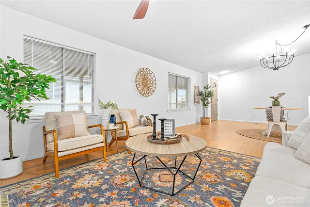 a living room with furniture and a potted plant