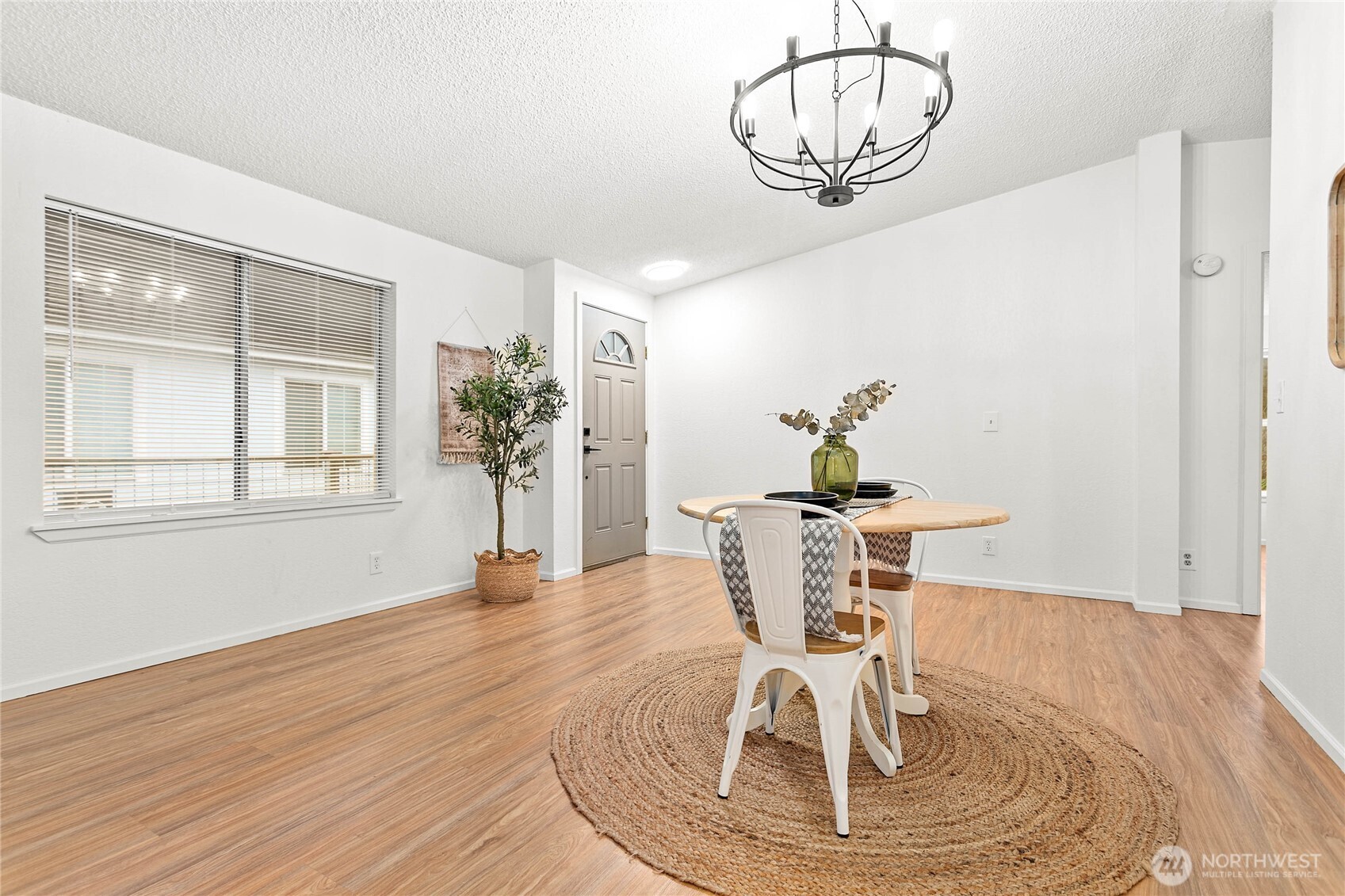 7343 Hannegan Road, Unit 2 Lynden, WA 98264 - Photo 14 of 34 a view of a dining room with furniture a chandelier and wooden floor