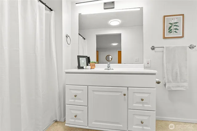 a bathroom with a sink vanity and a mirror