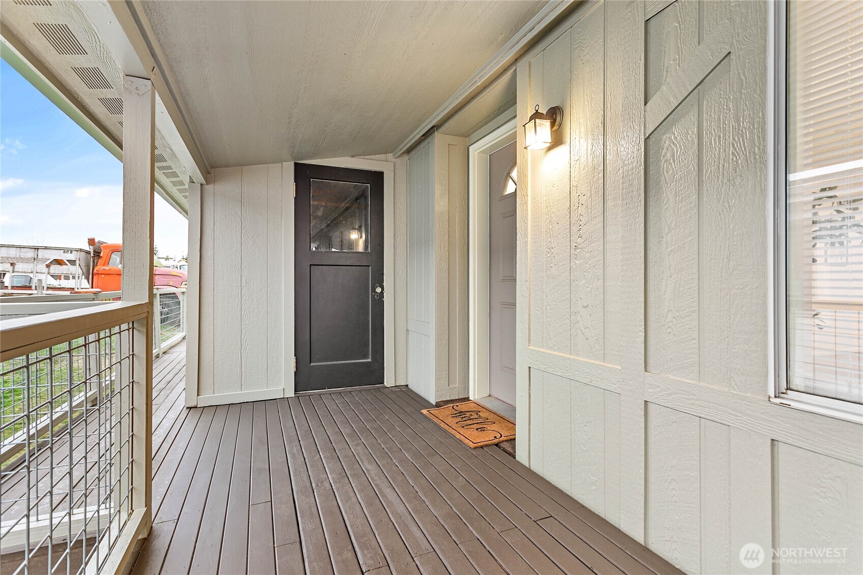 7343 Hannegan Road, Unit 2 Lynden, WA 98264 - Photo 2 of 34 a view of a hallway with wooden floor and staircase