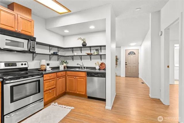 a kitchen with stainless steel appliances granite countertop a stove and a refrigerator