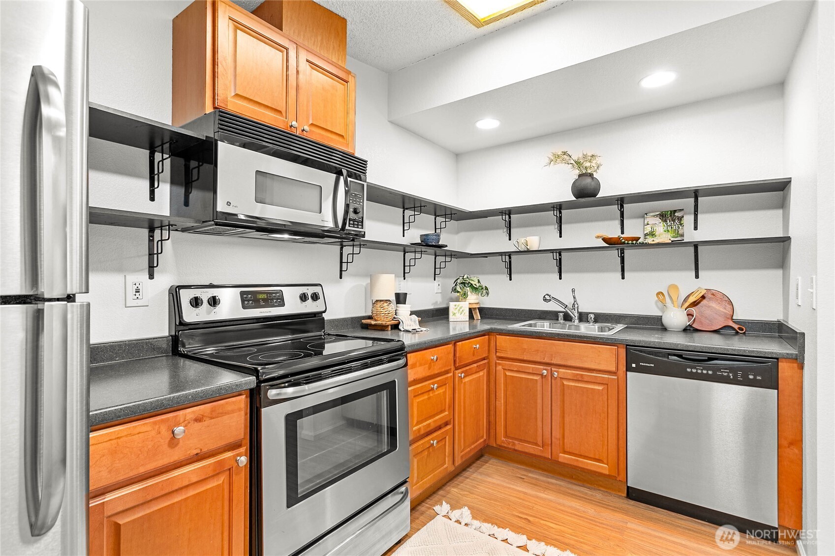 7343 Hannegan Road, Unit 2 Lynden, WA 98264 - Photo 22 of 34 a kitchen with stainless steel appliances granite countertop a stove a sink and a microwave